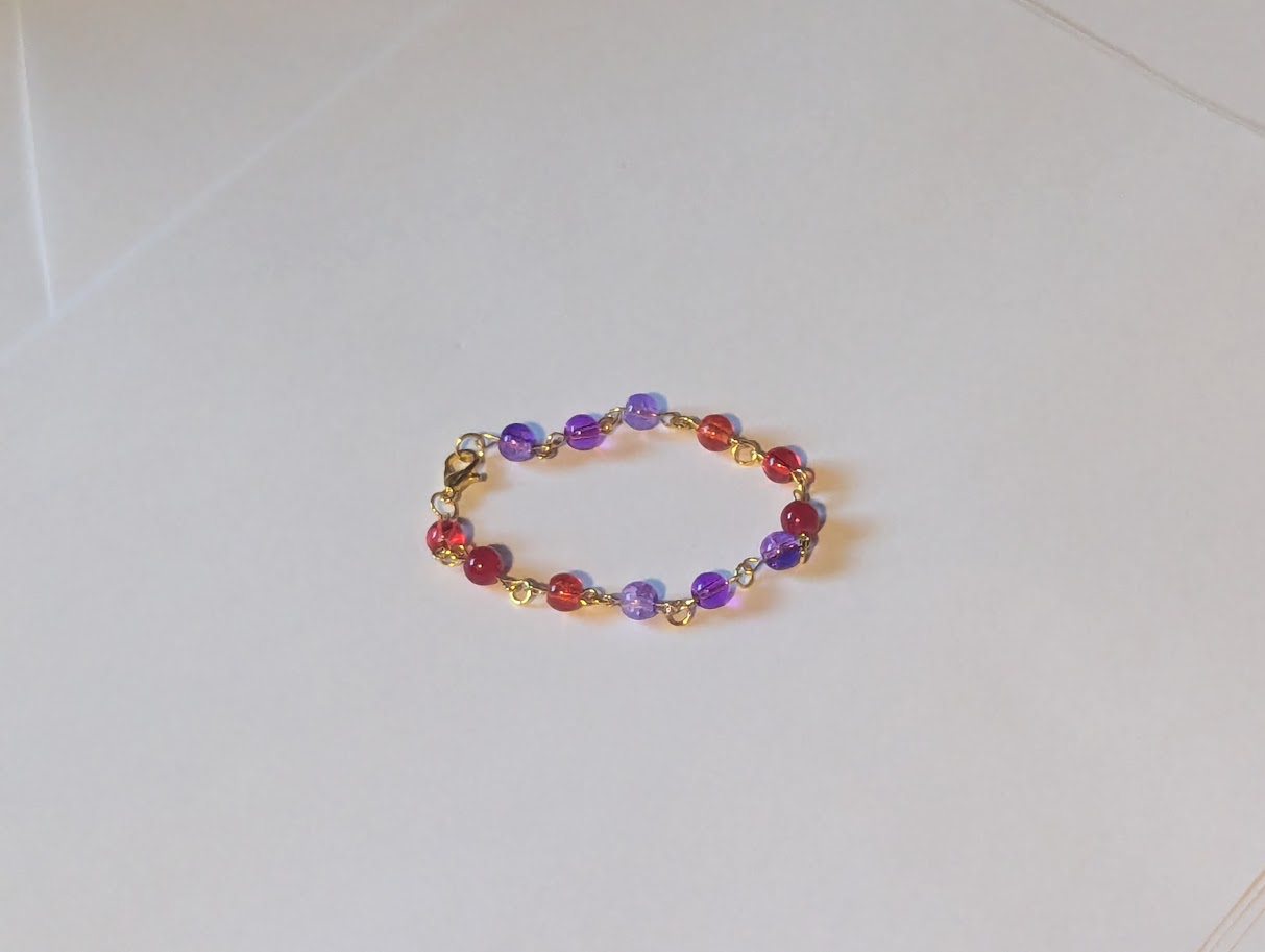 a purple and red charm bracelet